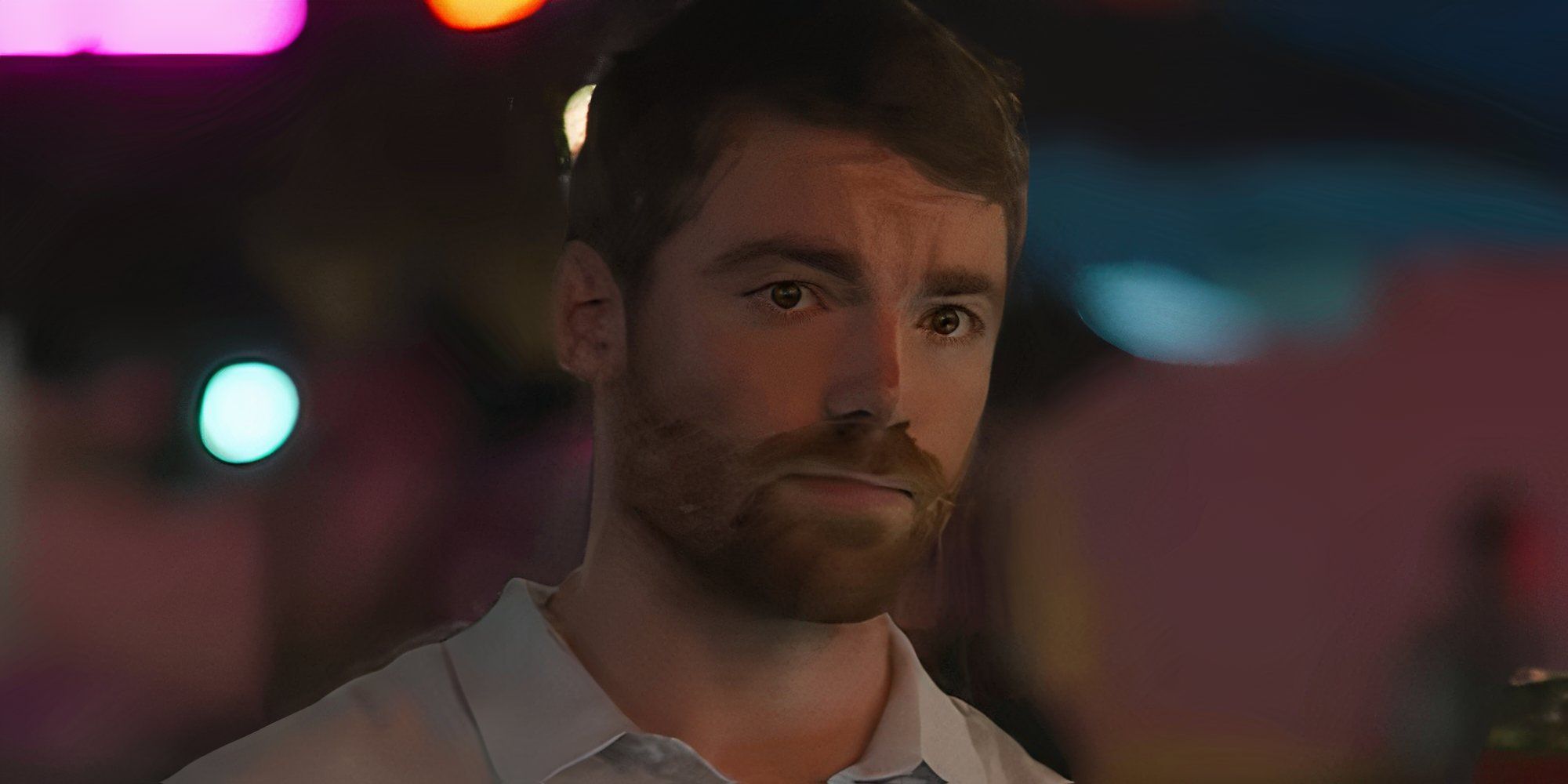 Gabriel Basso as Peter Sutherland looking at someone in The Night Agent season 2