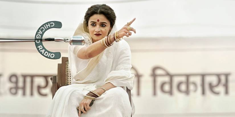 Gangubai Kathiawadi in front of microphone pointing finger