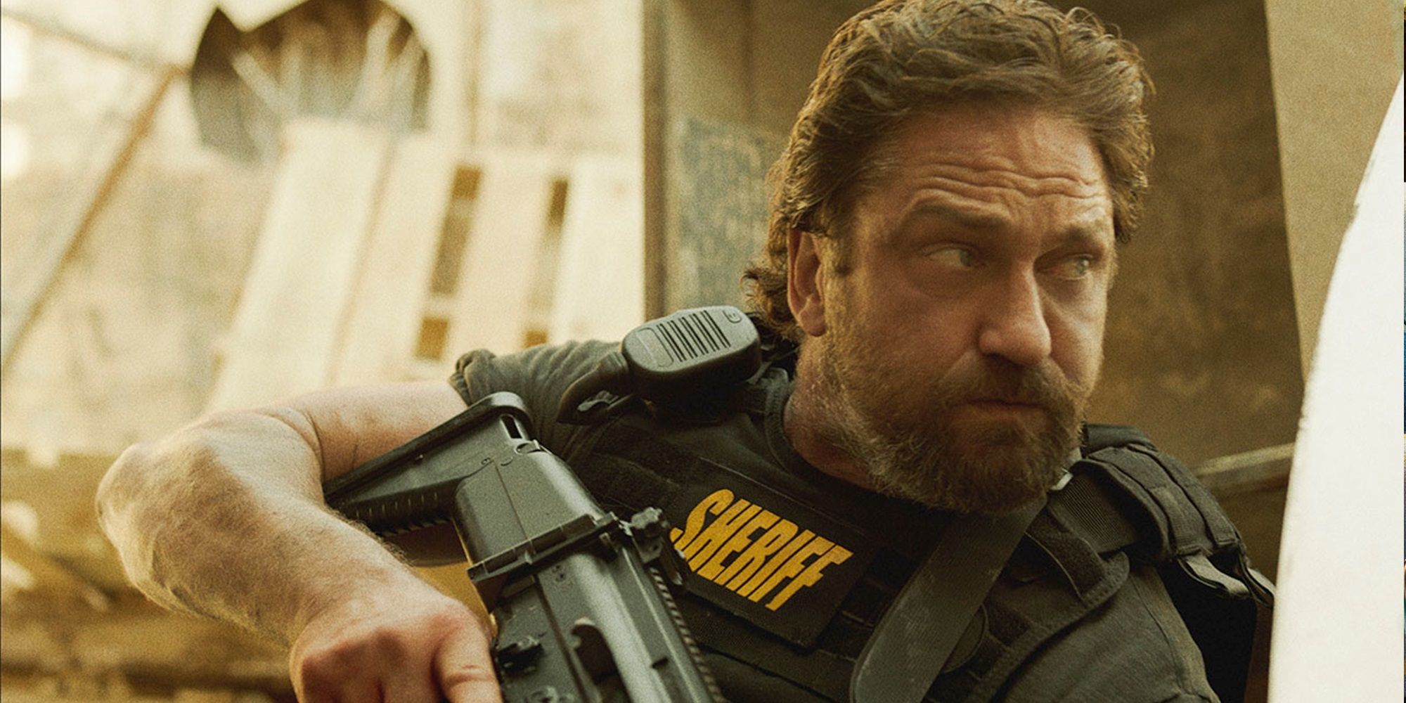 Gerard Butler holding a gun in Den of Thieves 2 Pantera