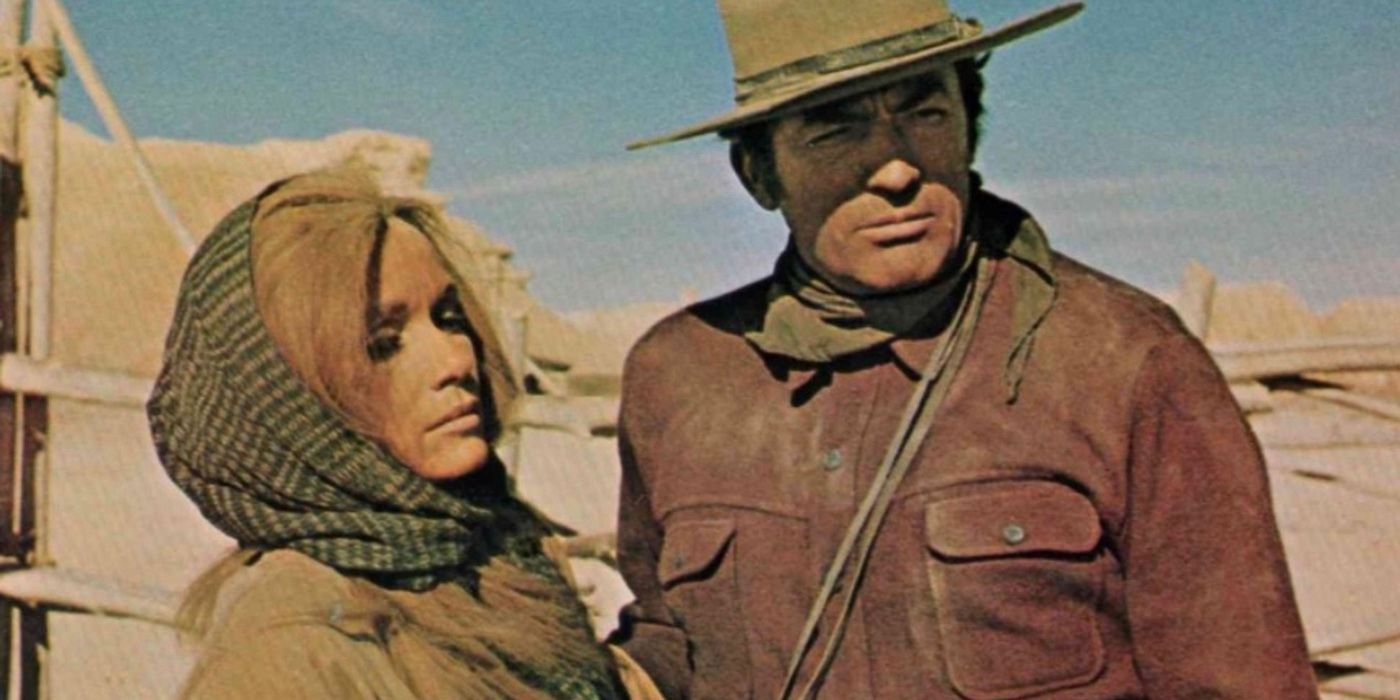 Gregory Peck and Eva Marie Saint stand next to one another outside.