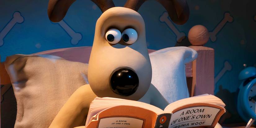 Gromit looking surprised while reading a book in bed in Wallace and Gromit Vengeance Most Fowl