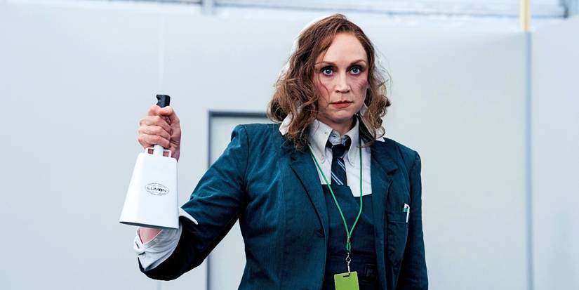 Gwendoline Christie holds a bell while standing with dirt on her face in Severance season 2