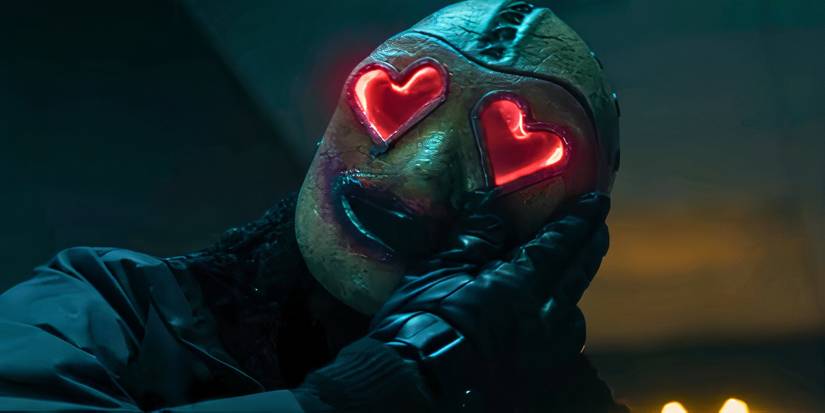 Heart Eyes killer with their hand on their mask