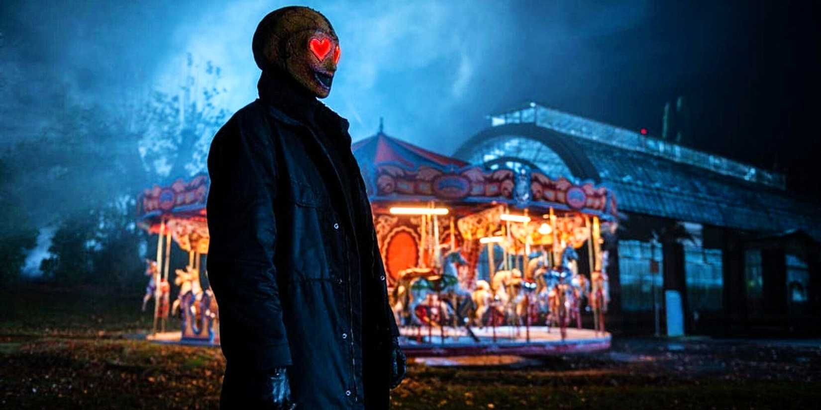 The Heart Eyes Killer Stalking A Victim In Front Of A Carousel In Heart Eyes