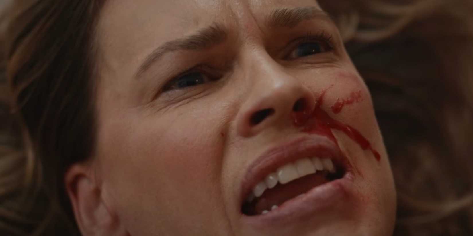 Hilary Swank looking scared with blood on her face in Yellowjackets season 3