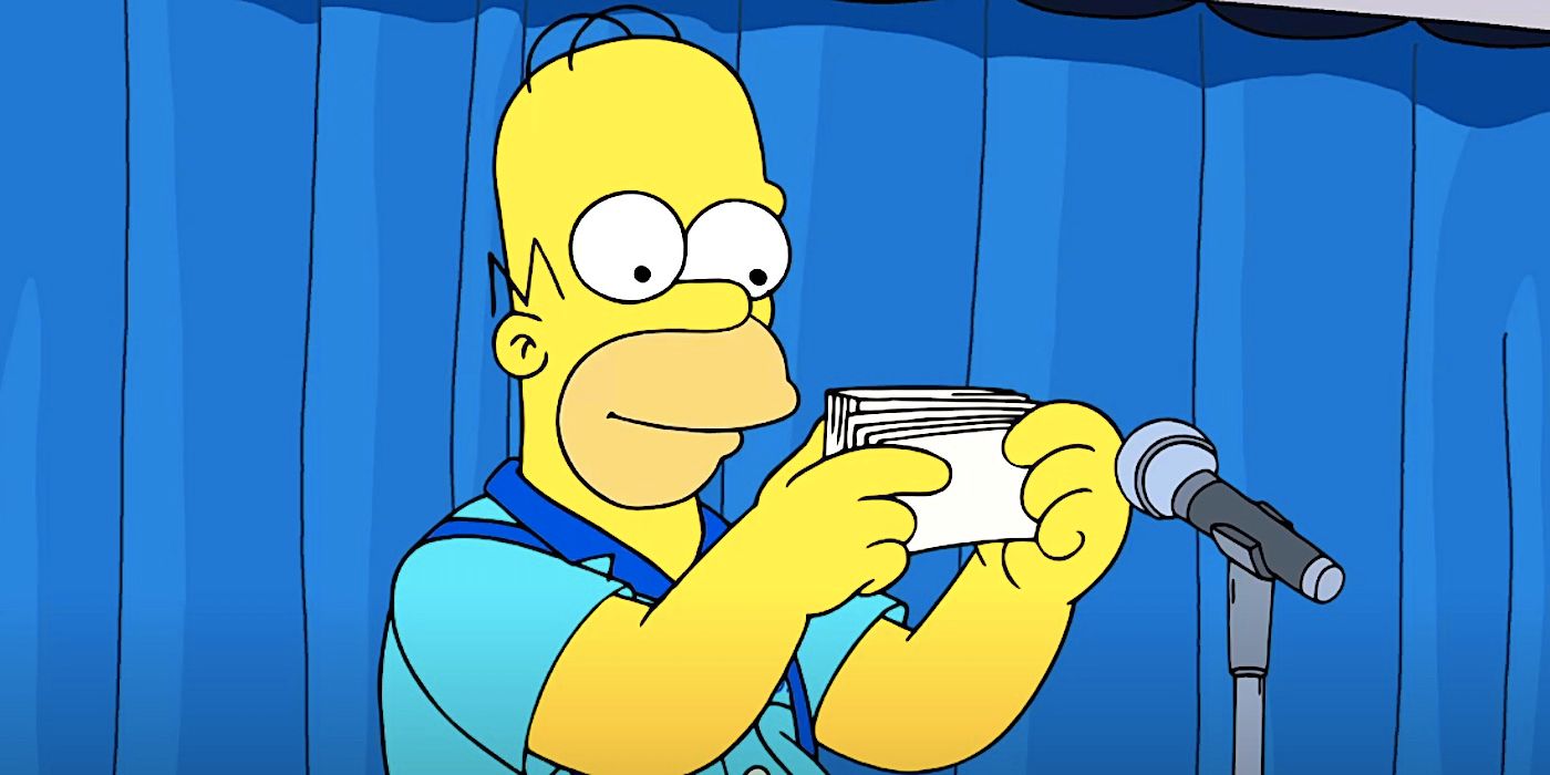 Homer smiles while reading cards at a microphone in The Simpsons season 36