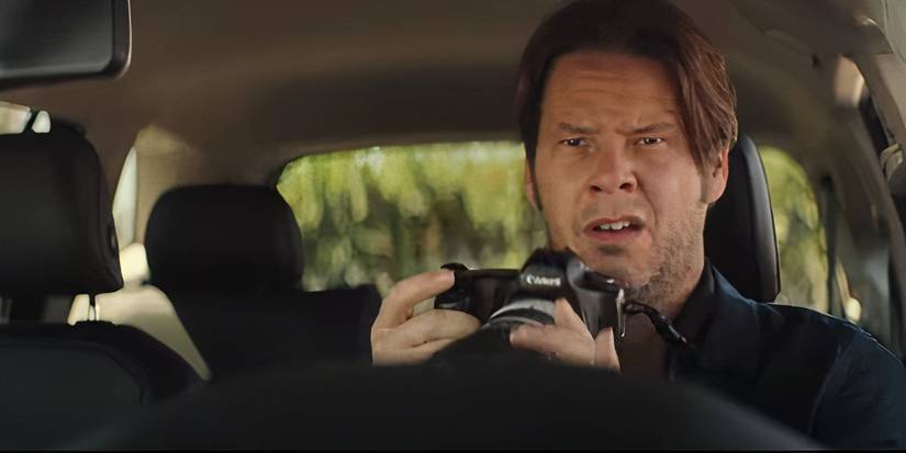 Ike Barinholtz as Martin Etten with a camera in The Unbearable Weight of Massive Talent