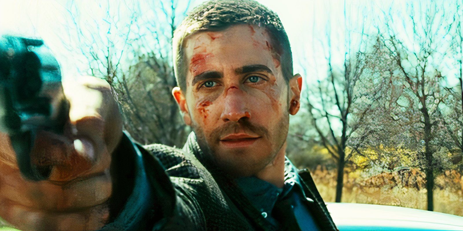 Jake Gyllenhaal pointing a gun in Source Code