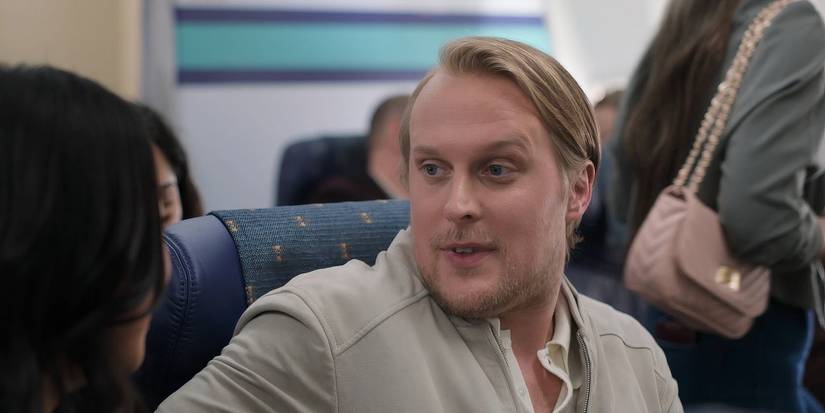 John Early sits on a plane in Peacock's Laid