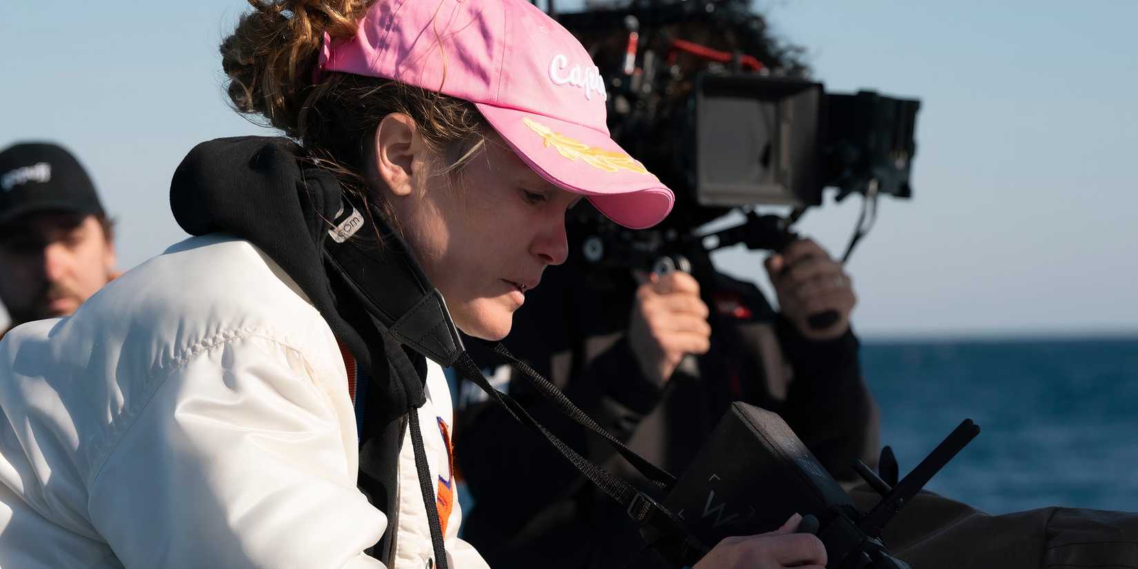 Julia Stiles reviewing something on a monitor in Wish You Were Here