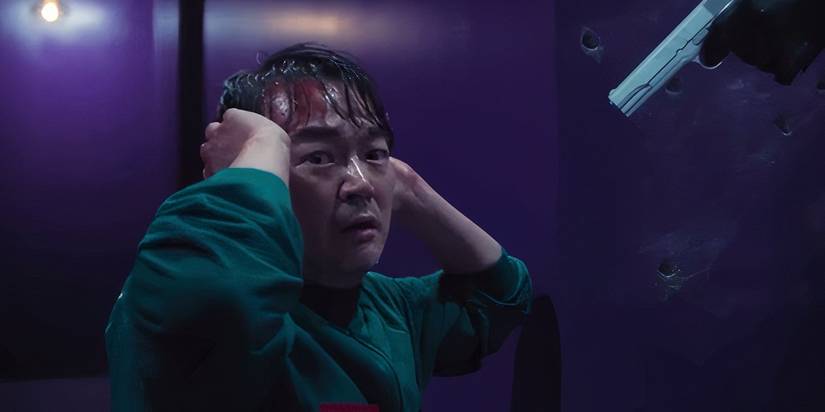 Jung-bae with a gun pointed at him in Squid Game season 2's finale