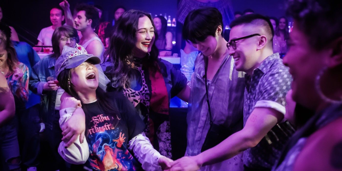 Lily Gladstone and Bowen Yang dance with friends in The Wedding Banquet