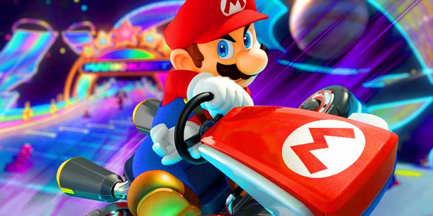 Mario from Mario Kart 8 posing in front of the Rainbow Road course