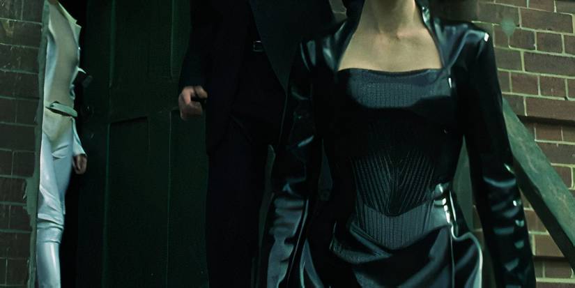 Carrie-Anne Moss as Trinity in a black vinyl dress in The Matrix.