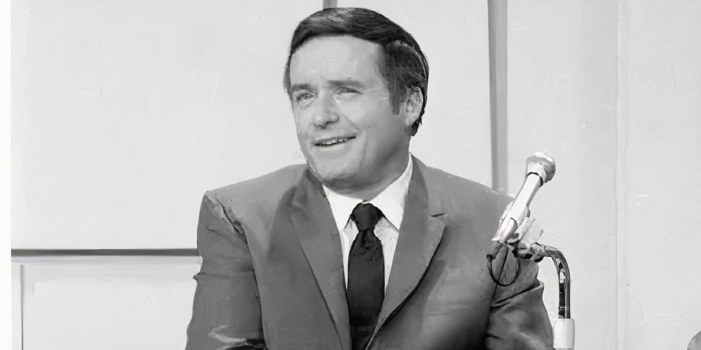 Mike Douglas, talk show host, sitting in front of a microphone