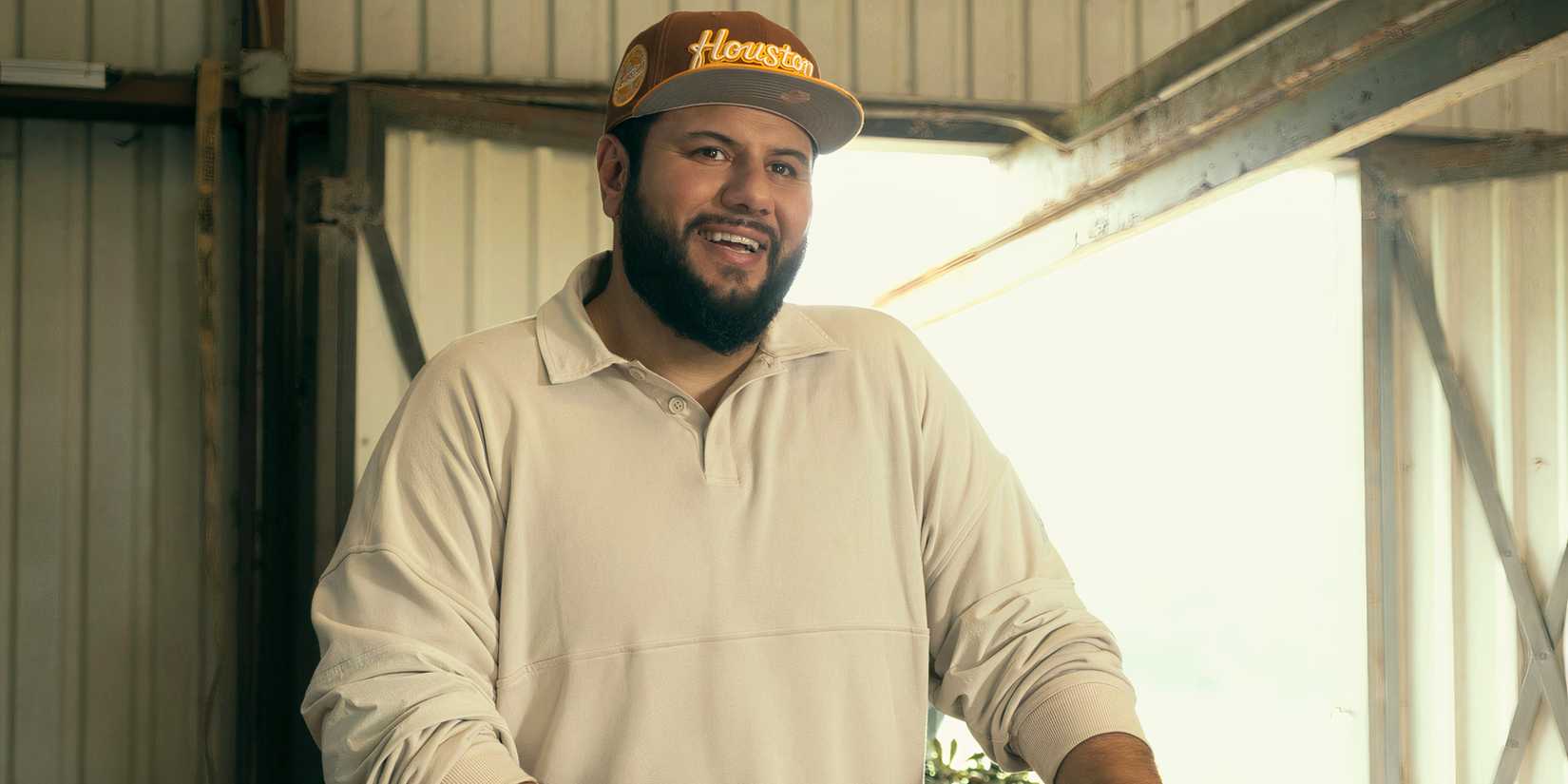 Mo smiles wearing a hat in Mo season 2