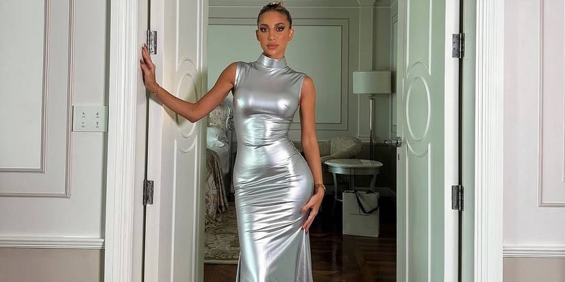 Dubai Bling season 3's Model Roz in a silver dress posing in a doorway