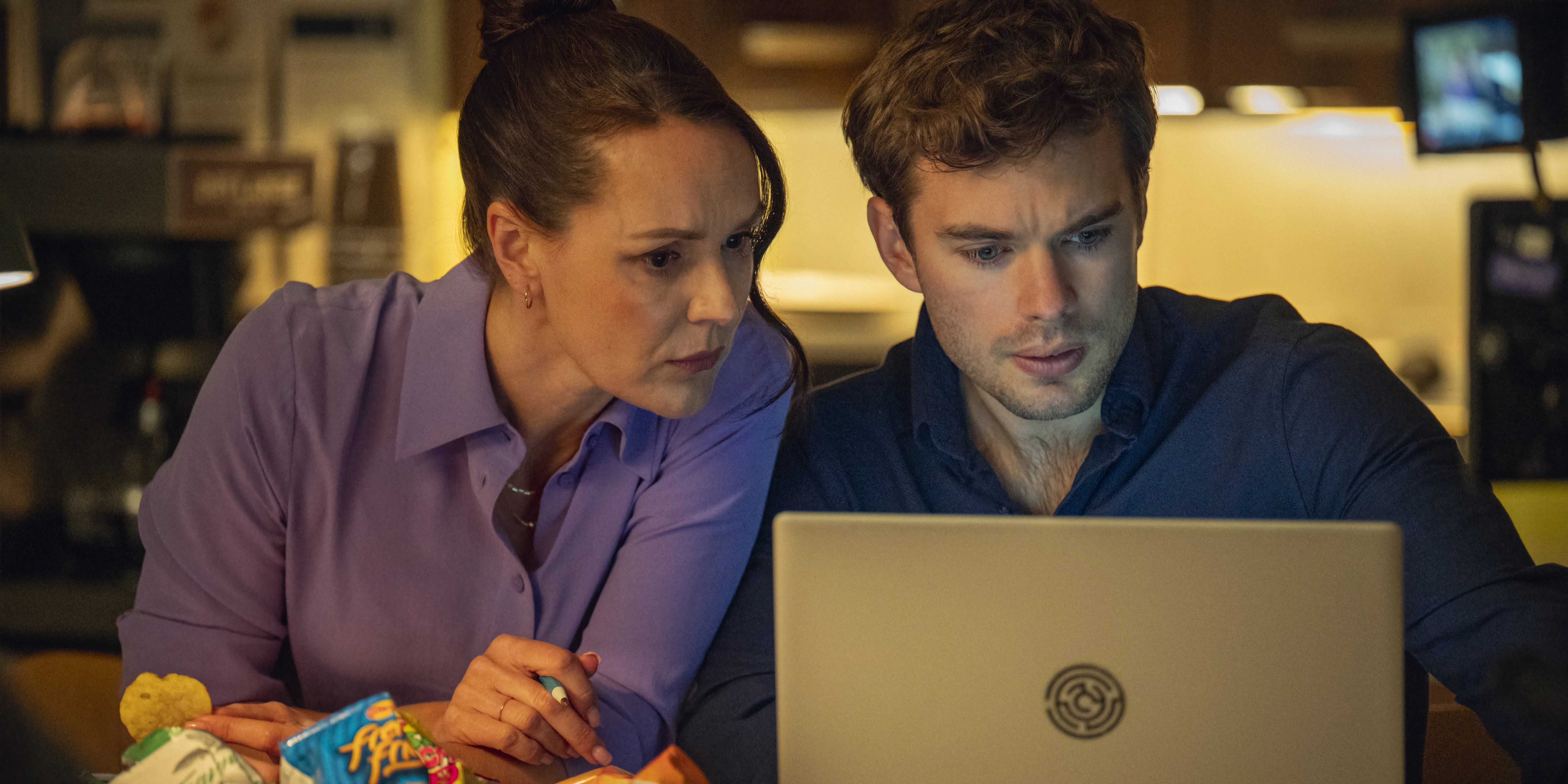 Charlie and another police investigator look at a computer in Netflix's Missing You