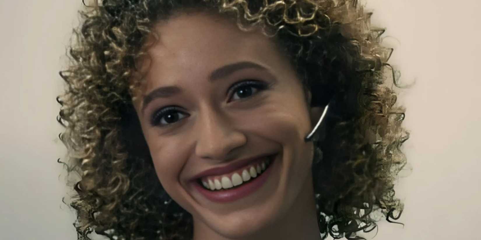 Natalie smiling with her earpiece in Severance season 1