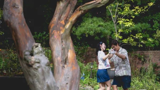 No Other Choice Park Chan-Wook Lee Byung-hun and Son Ye-jin dancing in a yard