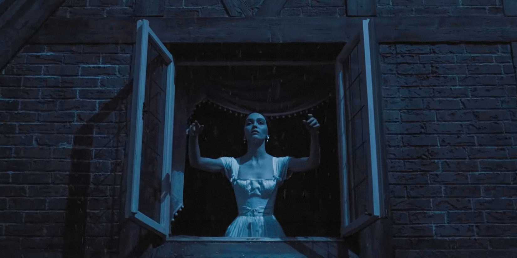 In the dead of night, Ellen Hutter (Lily-Rose Depp) throws open the windows of her room wide open in Nosferatu