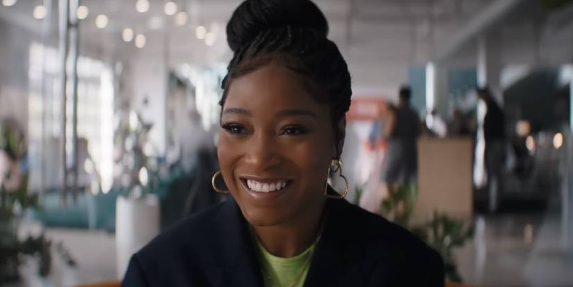 Keke Palmer as Dreux smiling in an office in One of Them Days