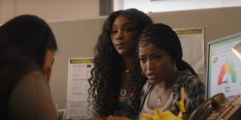 Keke Palmer looking incredulous next to SZA in an office in One of Them Days