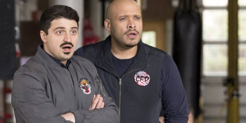 Otis and Cruz looking shocked as they stare at something in the distance on Chicago Fire
