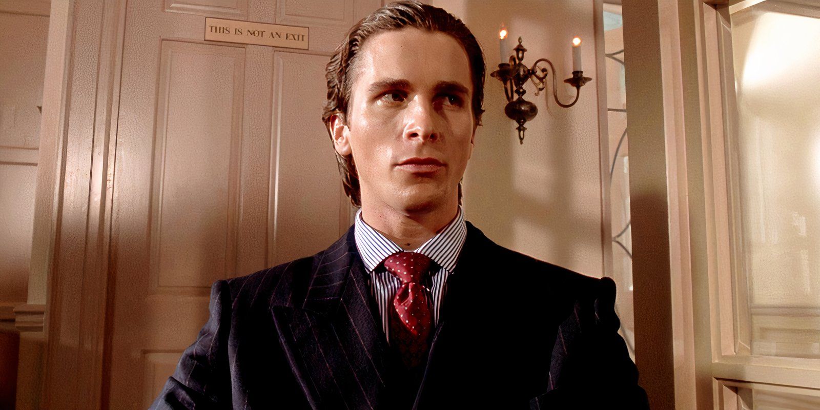 Patrick Bateman looking nervous as he glances to the side in American Psycho