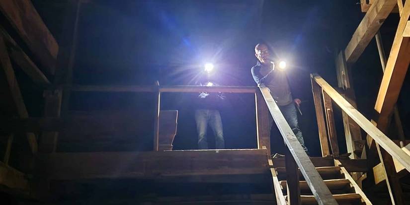 People shining lights into a mine shaft in Horror in the High Desert.
