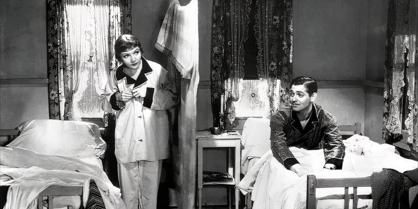 Peter and Ellie are by their twin beds in the hotel room in It Happened One Night