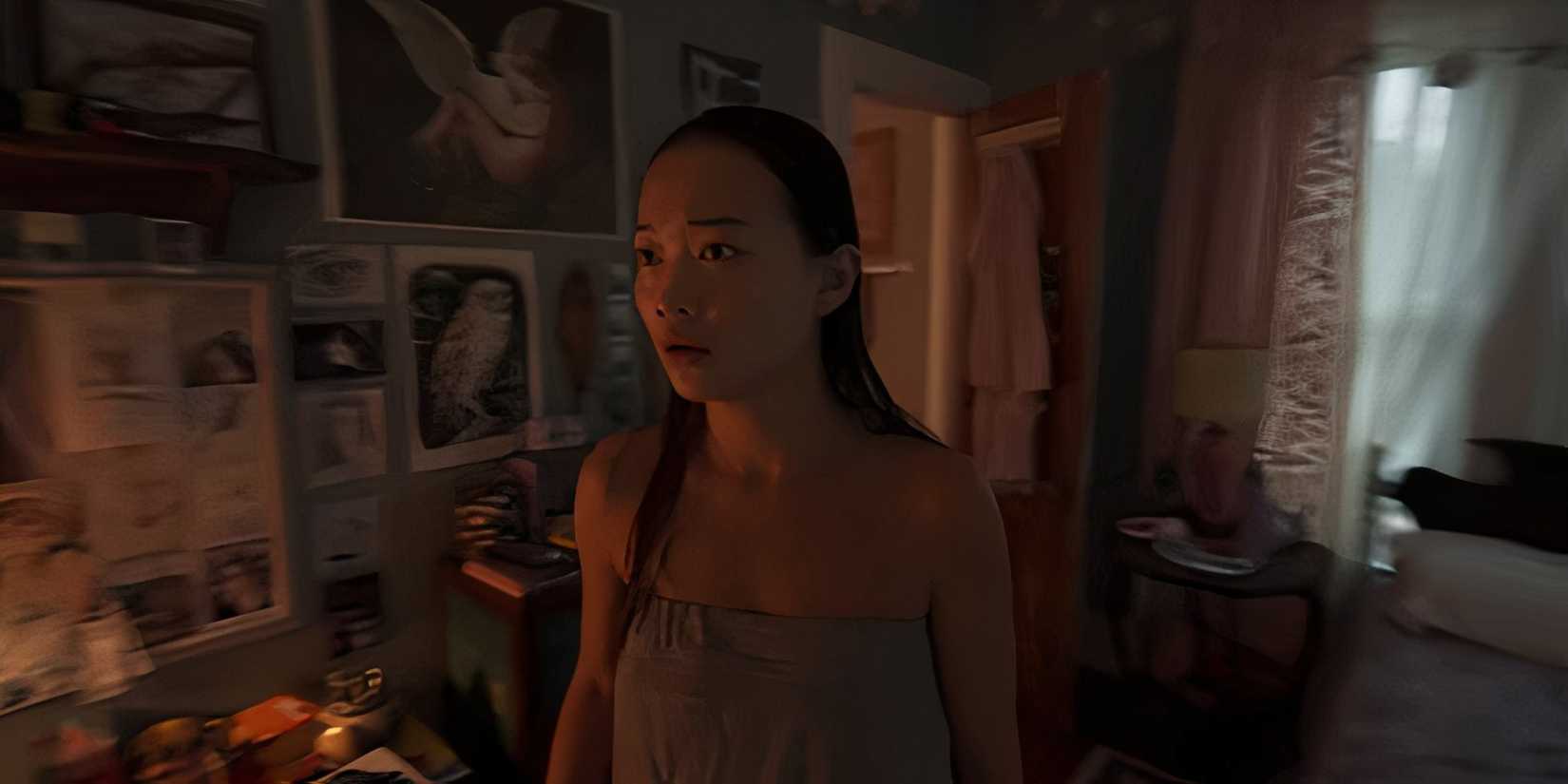 Chloe wearing a towel in her room in Presence