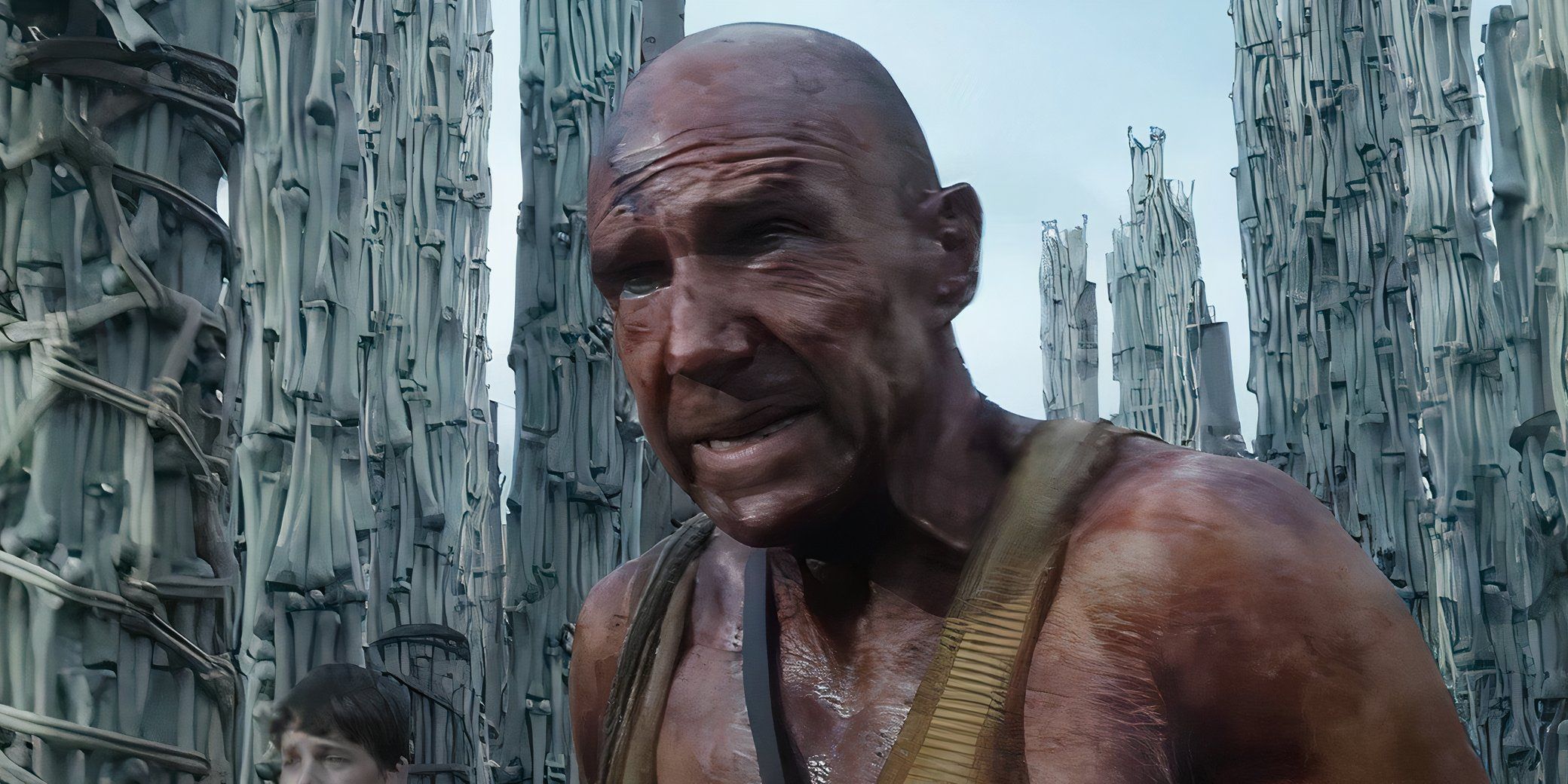 Ralph Fiennes standing among towers of bones in 28 Years Later