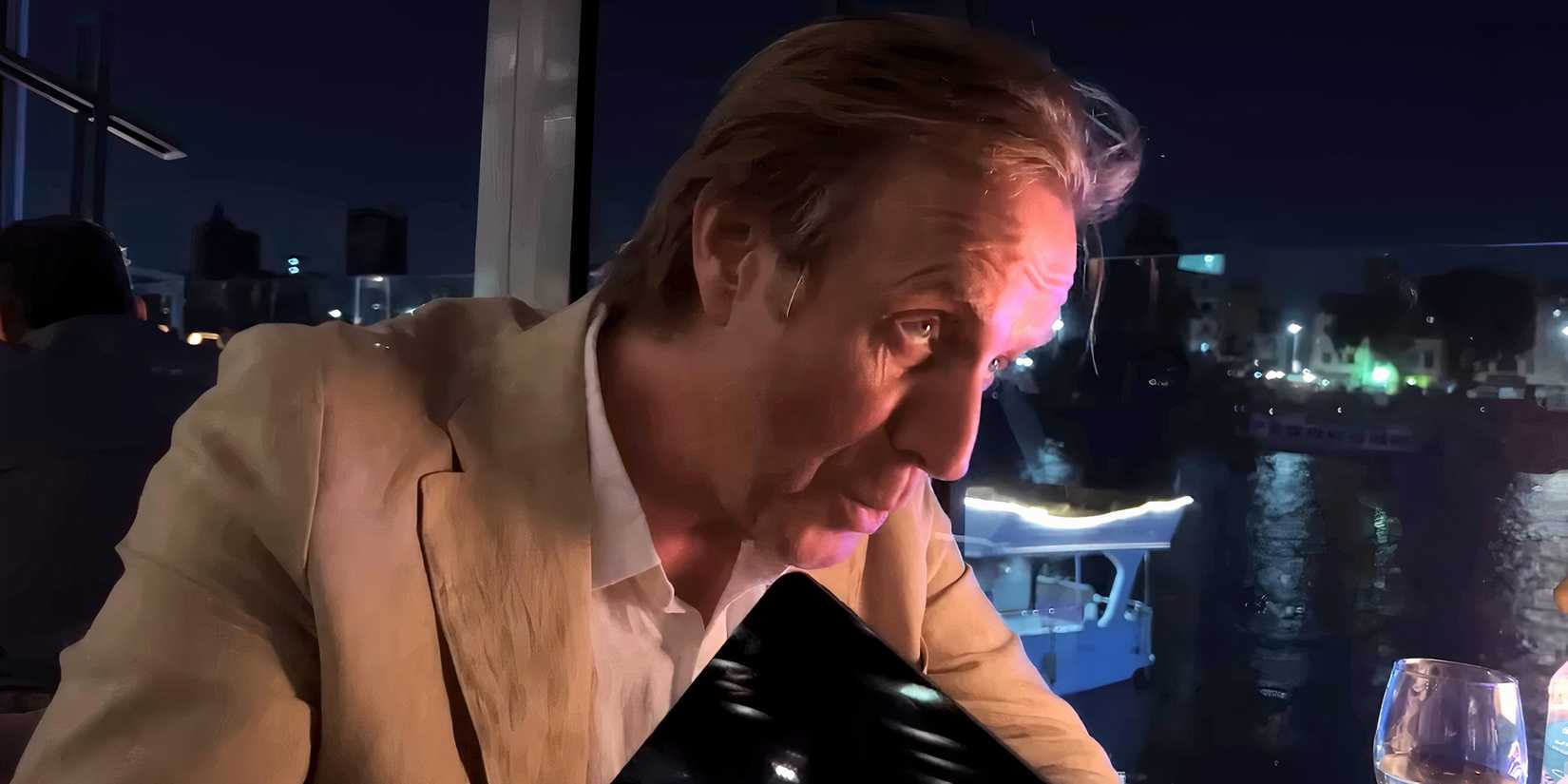 Rhys Ifans' Sam talking while sitting at a restaurant table in Inheritance-1