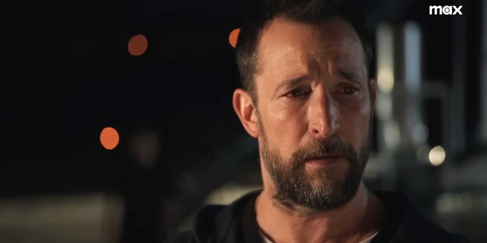 Dr. Michael "Robby" Robinavitch (Noah Wyle) looking devastated on the roof of the hospital in a trailer for The Pitt