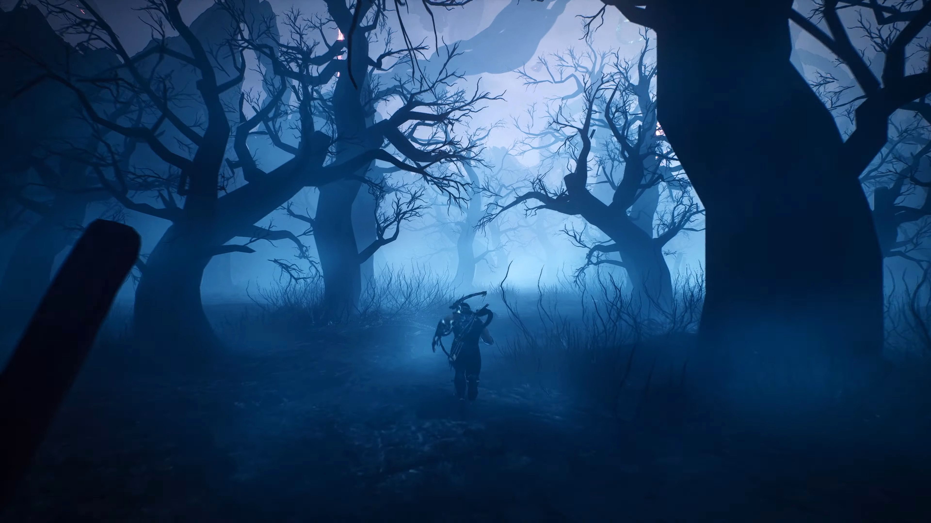 Ryu runs through a dark forest in a screenshot from Ninja Gaiden 2 Black.