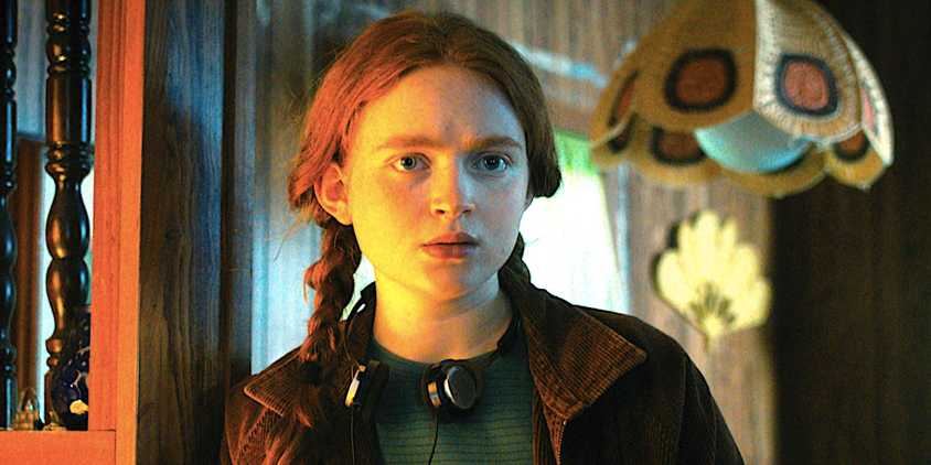 Sadie Sink's Max stands in a doorway and stares in Stranger Things season 4