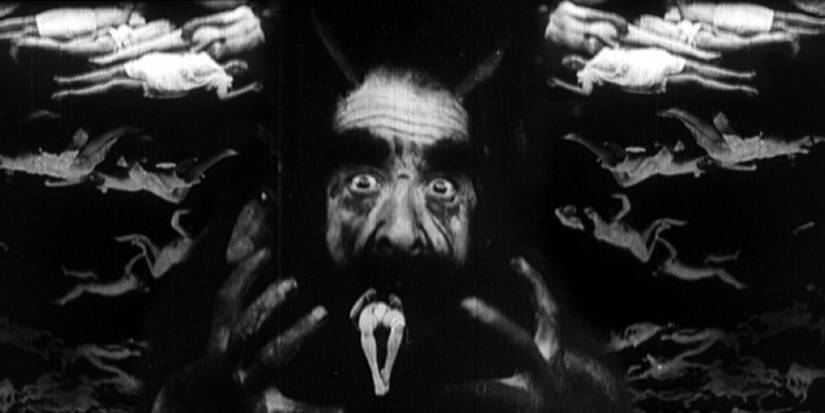 Salvatore Papa as Dante Alighieri surrounded by demons in Dante's Inferno.
