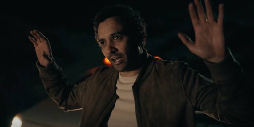 Sami holds his arms out in The Night Agent season 2