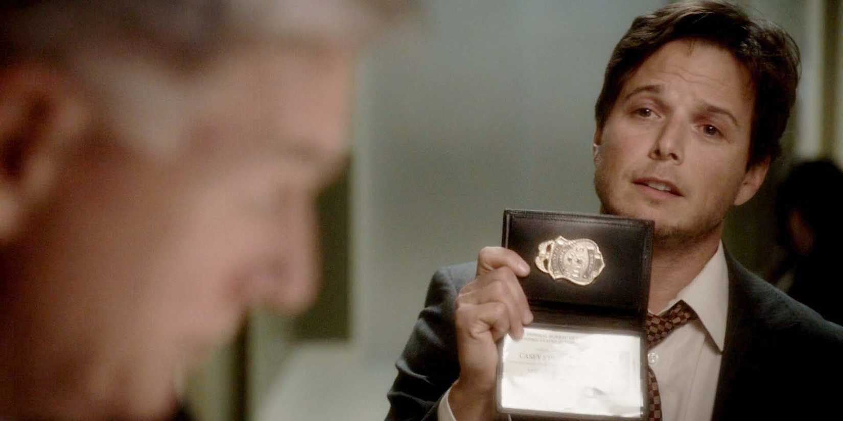 Scott Wolf as Casey in NCIS, as he's holding up an FBI badge