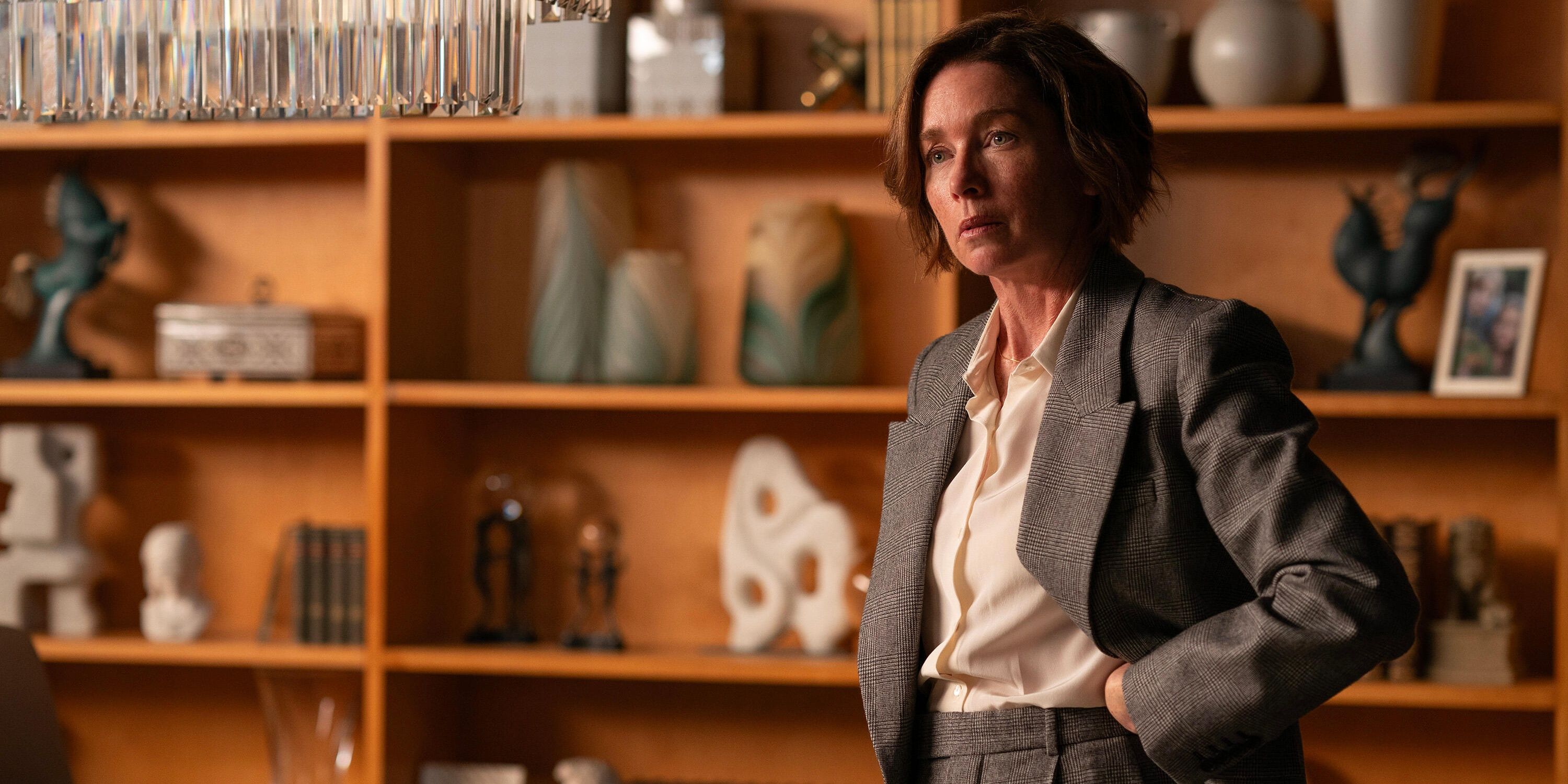 Julianne Nicholson as Sinatra standing by a bookcase in Paradise season 1