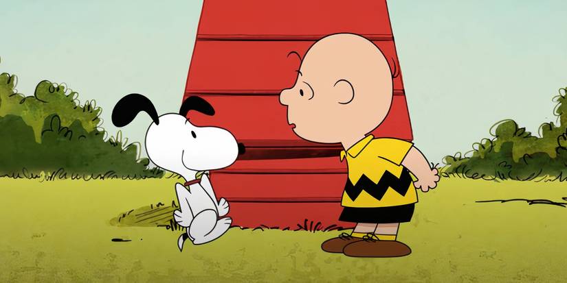 Peanuts' Snoopy dancing in front of Charlie Brown.