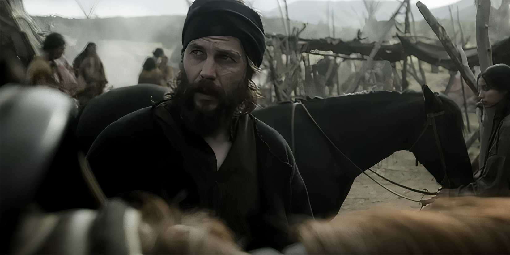 Taylor Kitsch's Isaac looking up at someone on a horse in American Primeval