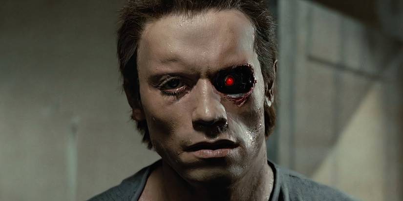 A Terminator with rubber skin, its red robotic eye shining through a damaged socket.