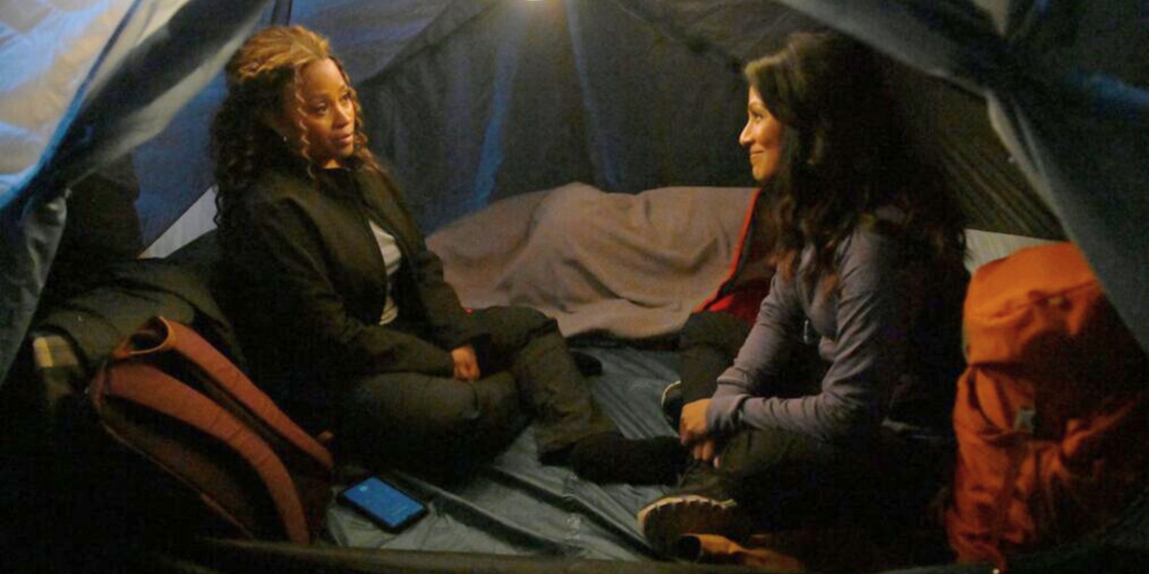 The Irrational Marisa and Rose sitting in a tent and talking