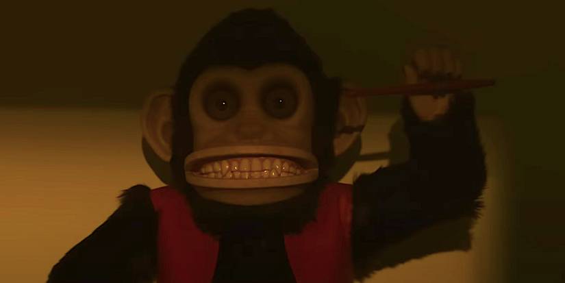 The monkey toy sitting in the dark from the trailer for 2025's The Monkey