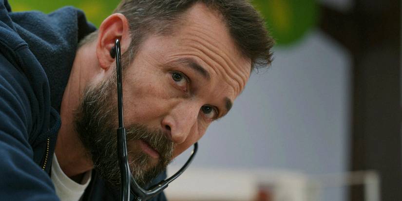 Noah Wyle using a stethoscope in The Pitt