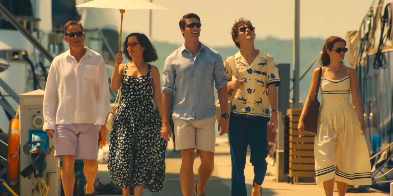 Guests walking along a pier in The White Lotus season 3