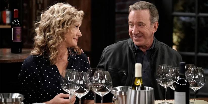 Tim Allen and Nancy Travis at a table full of wine glasses in Shifting Gears