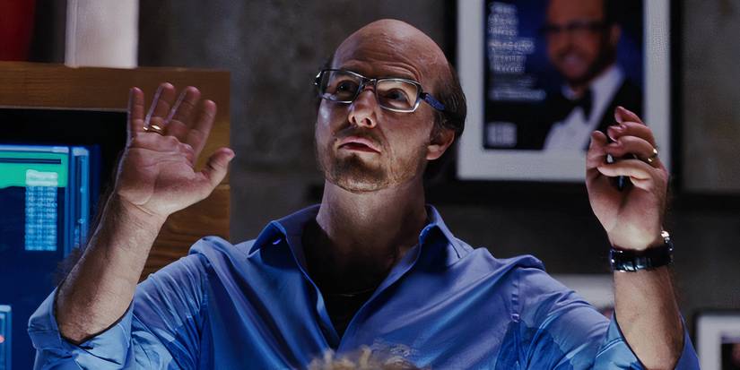 Tom Cruise with his hands raised as Les Grossman in Tropic Thunder